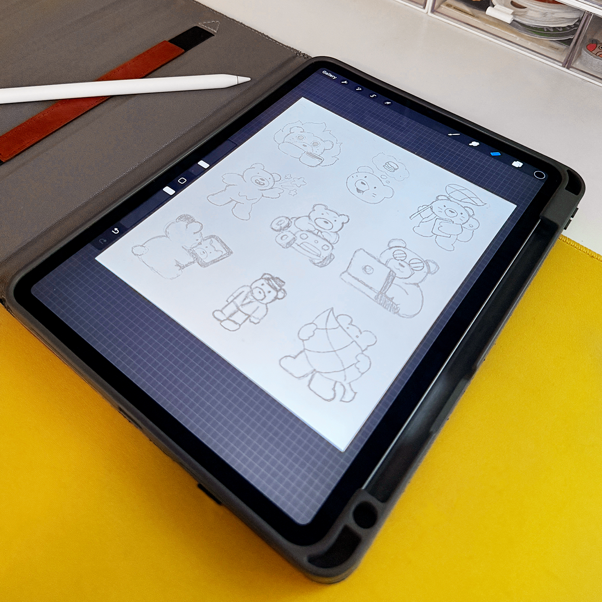 Tablet displaying sketches of cartoon bears in various poses, the first draft for StickerApp's Thank You card.