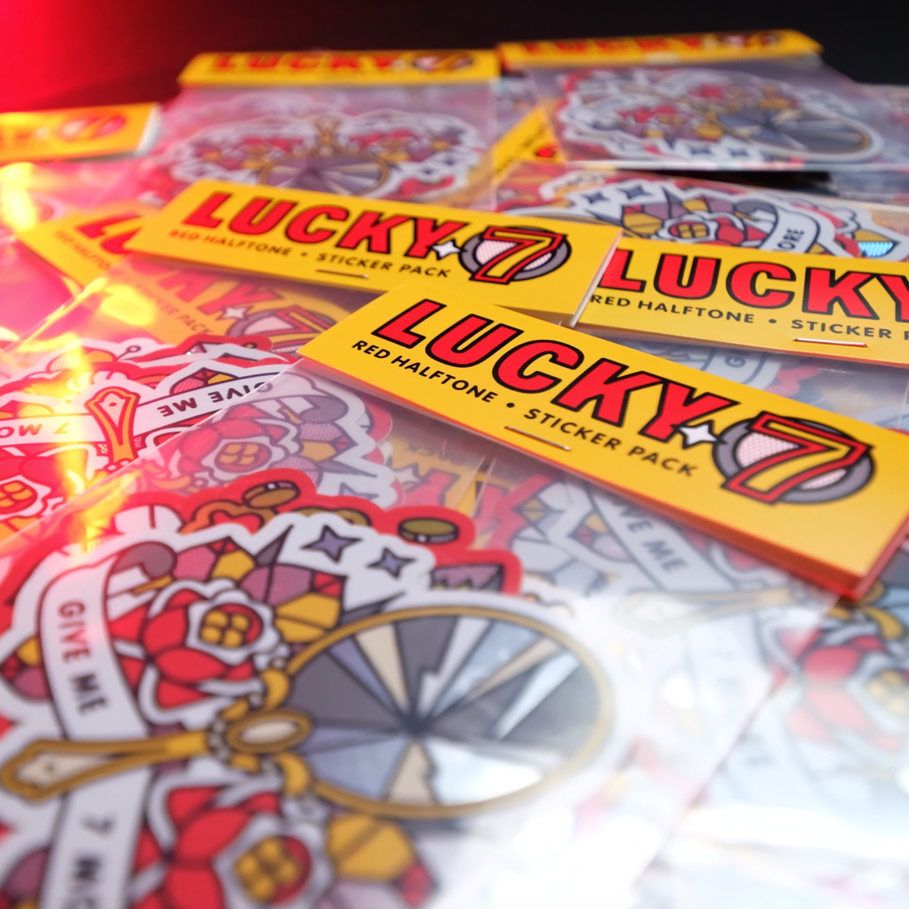 Close-up of colorful "Lucky 7" sticker packs with vibrant die cut sticker designs in holographic and glitter.