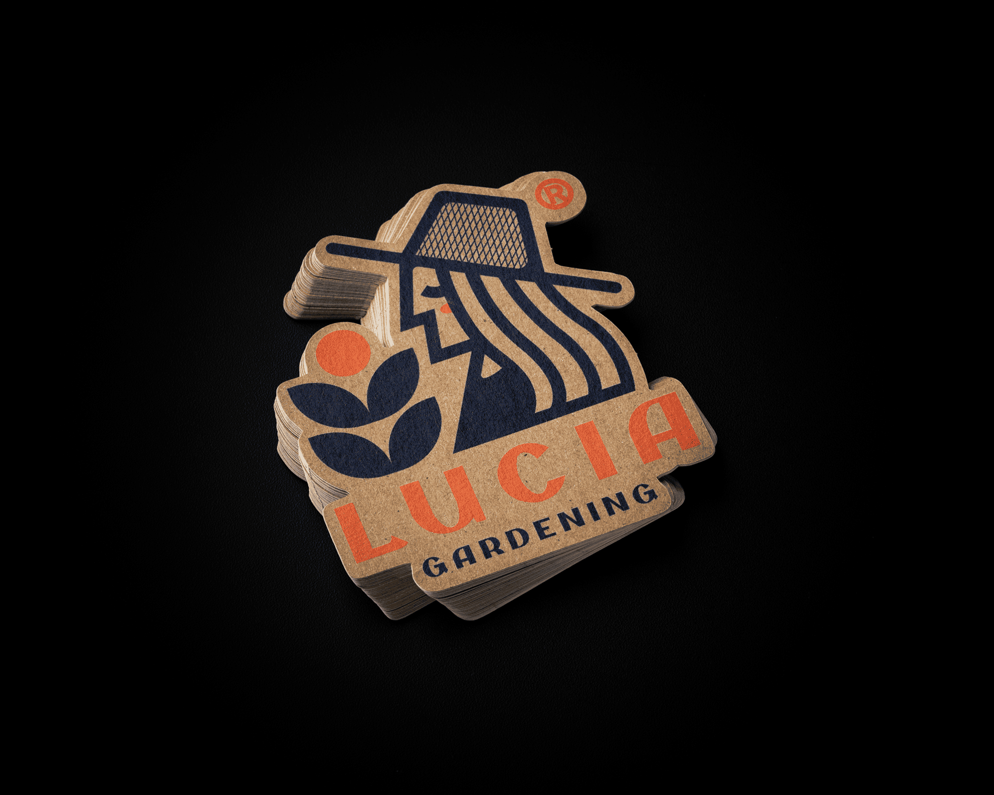 Stack of kraft stickers with a gardening logo featuring a hat-wearing figure, plant, and the text "LUCIA GARDENING" in orange and blue.