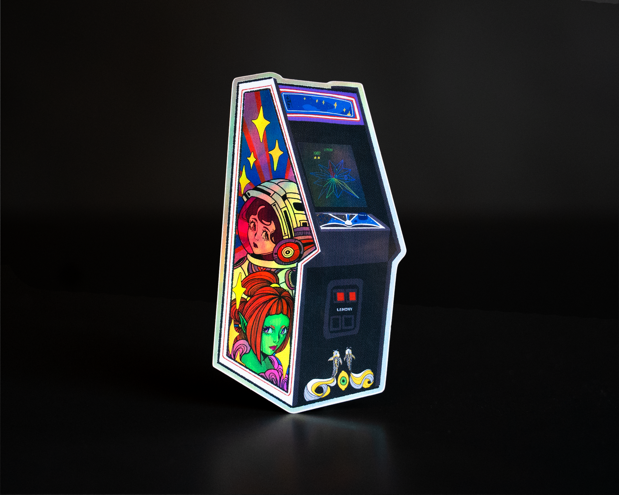A retro holographic arcade machine sticker with colorful artwork featuring futuristic characters, glowing screen, and joystick controls on a dark background.