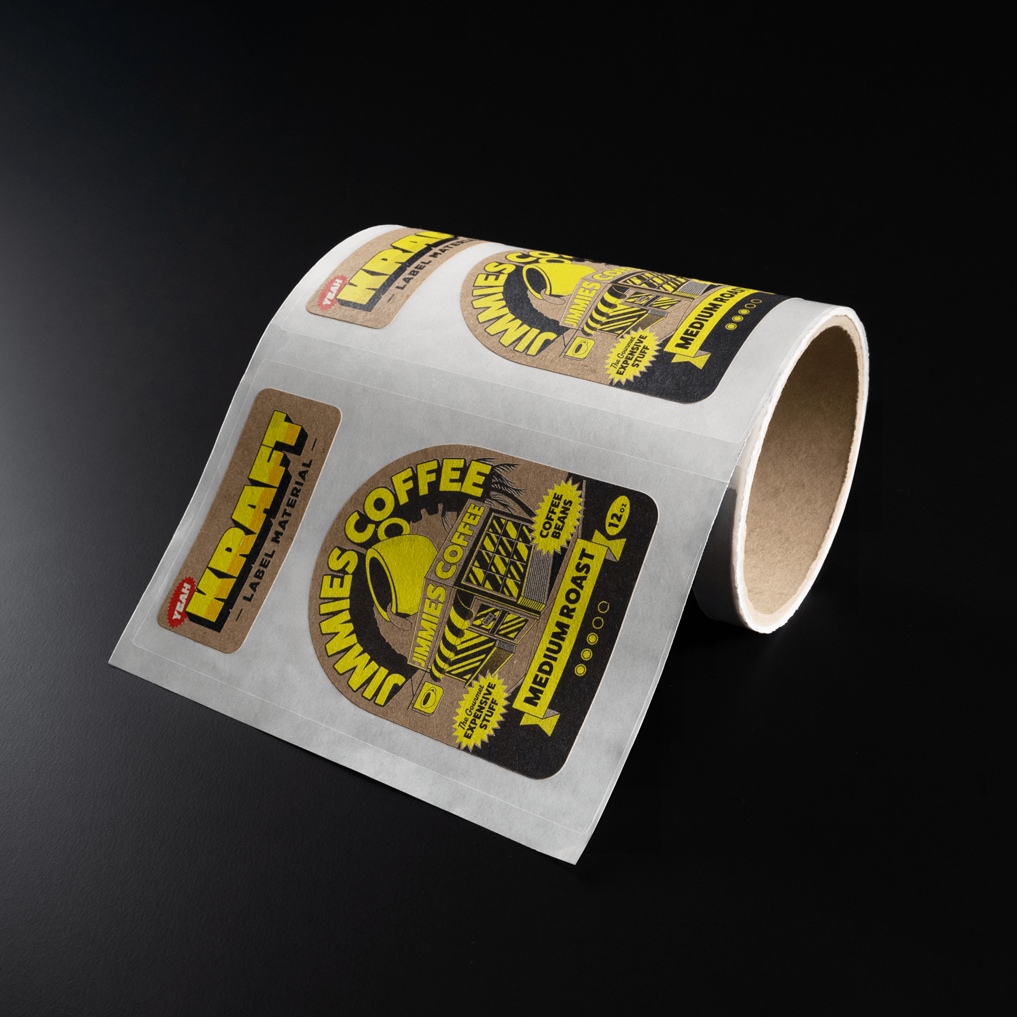 Roll of kraft paper labels with yellow and black design, labeled "Kraft" and "Minnie’s Coffee," on a dark surface.
