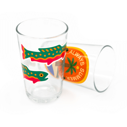 A shot glass with a custom stickers of a fish on it